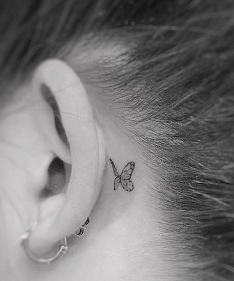 small butterfly tattoo behind ear
